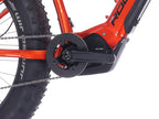 Lähikuva SÄHKÖPYÖRÄT.NETin Rock Machine Vyöry E90 -pyörästä, jossa näkyy sen kampiakseli, ketju, Shimano EP6 -moottori, paksut fatbike-renkaat, näkyvä ketjupyörä ja runkoon asennettu akku.